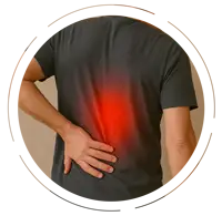 Middle-aged man touching his mid-back with his left hand, wearing a gray T-shirt and jeans, with a red glow highlighting mid-back pain.