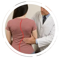 Chiropractor examining a young woman with scoliosis, showing a red line illustrating spinal curvature on her back, with a spine model in the background.