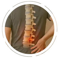 Man wearing a gray T-shirt and jeans, pressing his lower back, with a medical illustration overlay showing a herniated disc highlighted in red